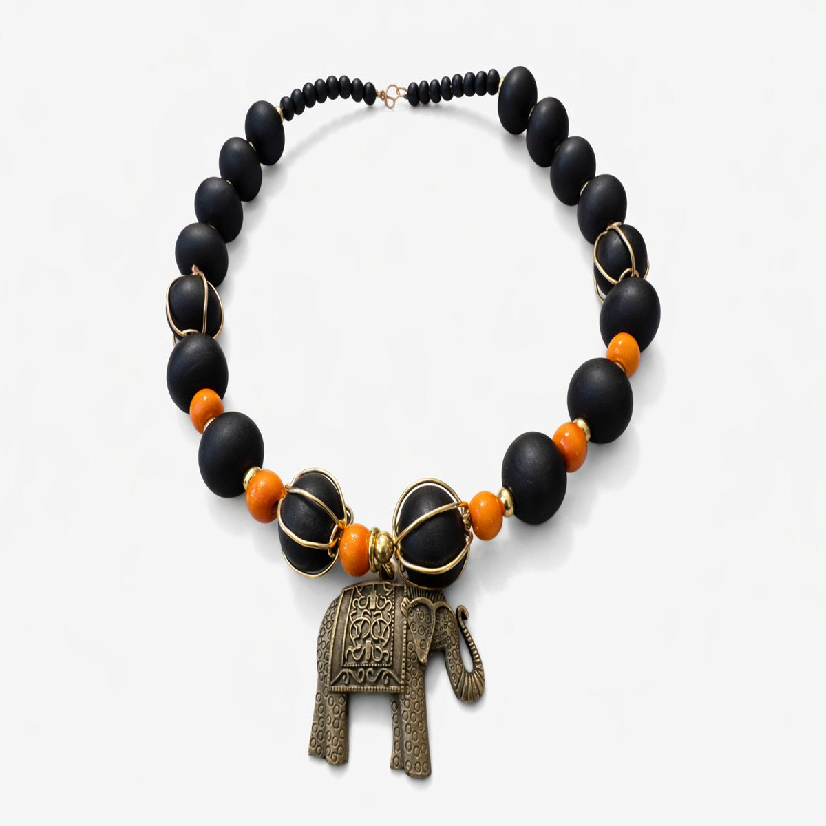 Crowned in Strength Elephant Necklace - Afrocentric statement jewelry with matte black beads, orange accents, and gold elephant pendant