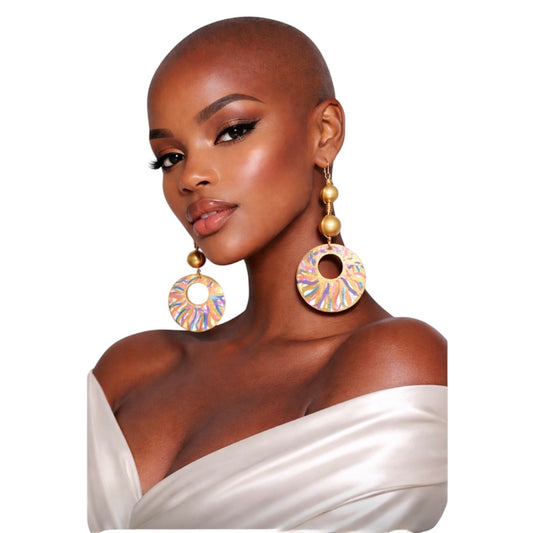 Dark skin bald woman wearing Afrocentric golden radiance color splash statement earrings on clean white background facing forward