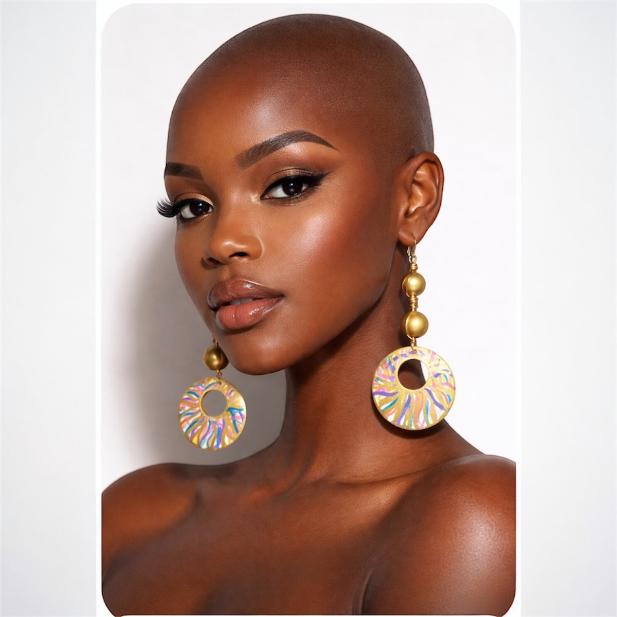 Alt Text:
Side view of dark skin bald woman wearing Afrocentric golden radiance statement earrings