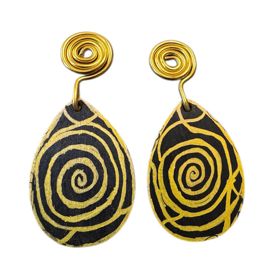 Afrocentric black and gold spiral wood statement earrings with handcrafted swirl design and gold coil hooks on clean white background