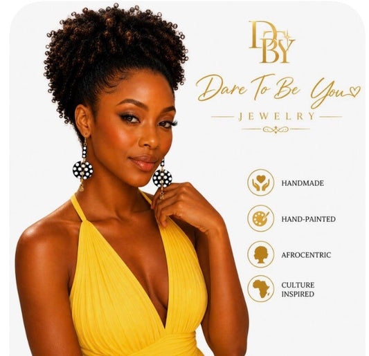 Sophisticated Black woman wearing handmade Afrocentric black and white polka statement earrings with gold accents on a clean white background by Dare To Be You Jewelry.