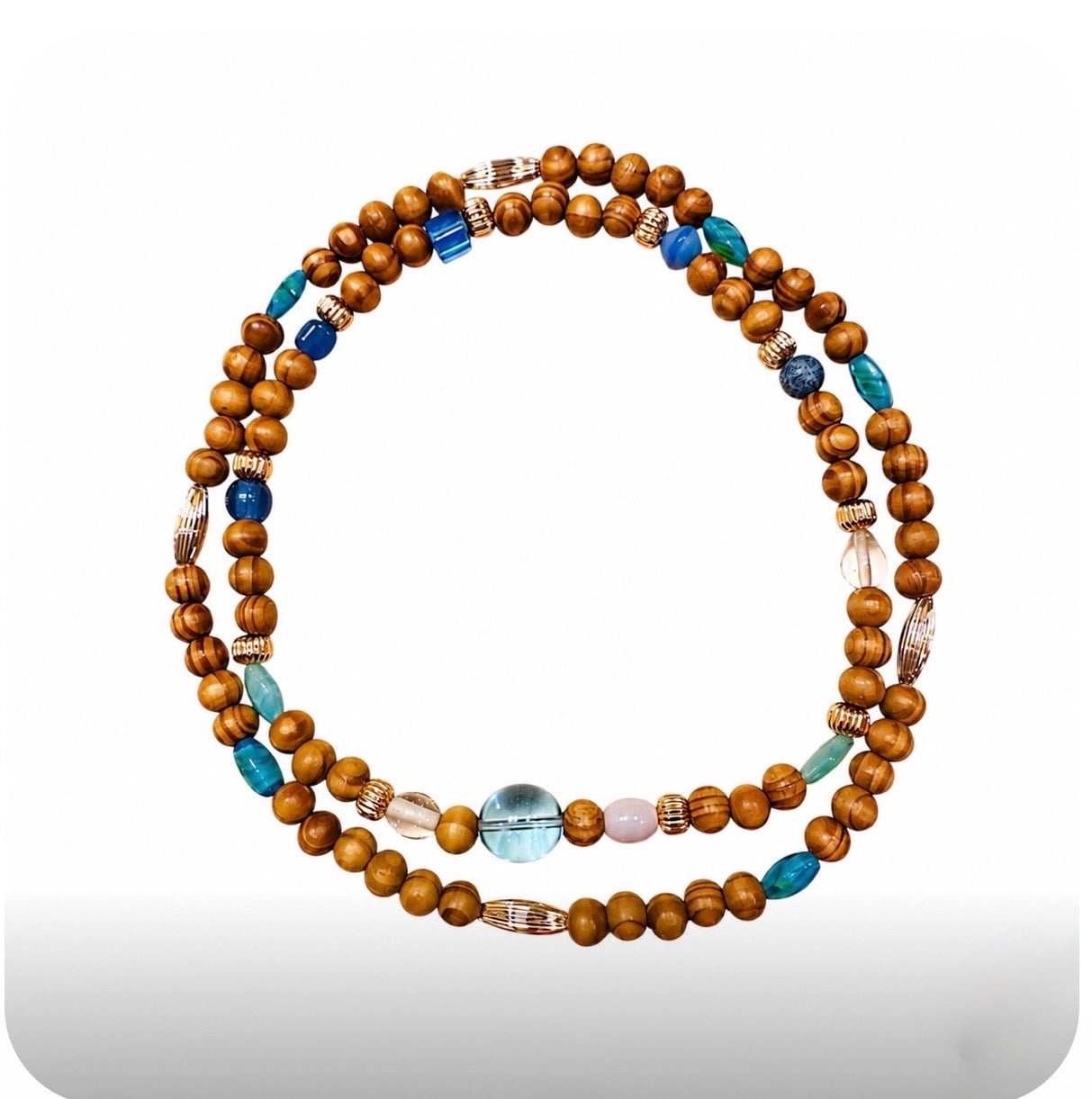 Handmade Afrocentric turquoise earth harmony necklace set with brown wood beads, turquoise blue glass beads, and gold accent beads on white background.