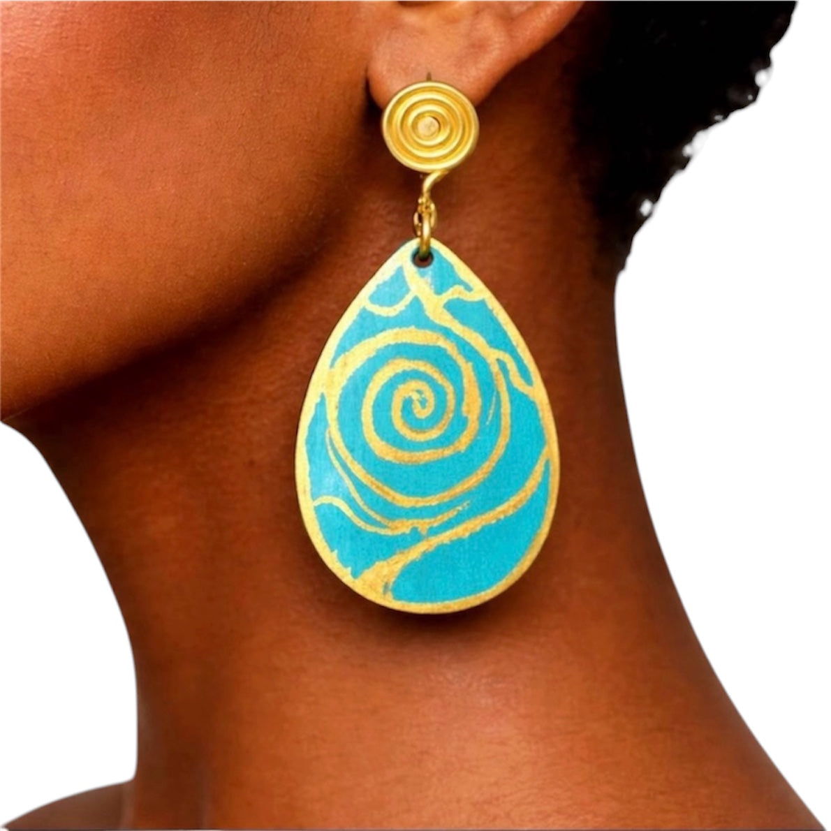 Close-up of turquoise and gold Afrocentric wooden statement earrings showing hand-painted spiral detail