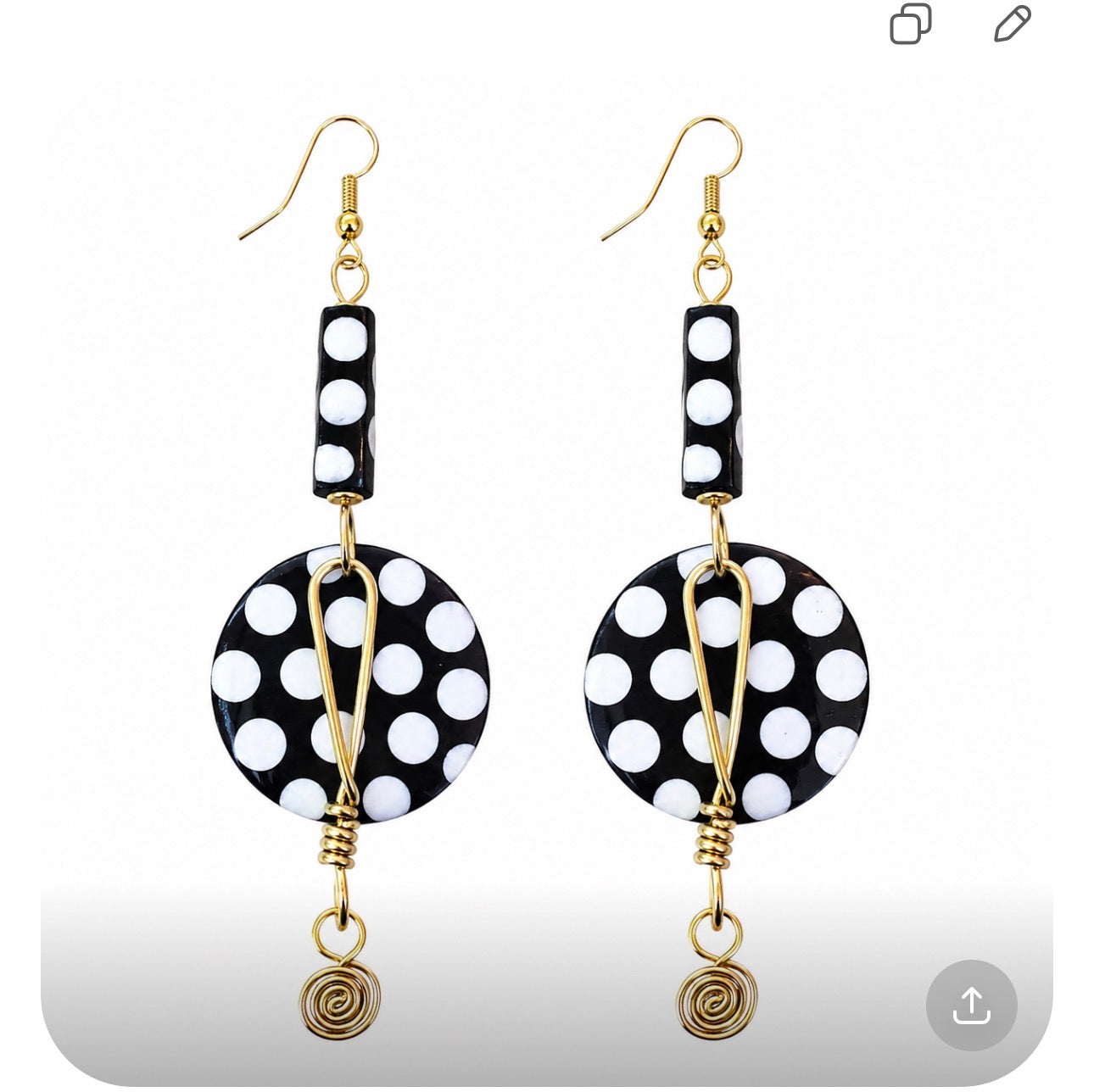 Lightweight handmade Afrocentric black and white statement earrings with gold detailing photographed on a white background for Dare To Be You Jewelry.
