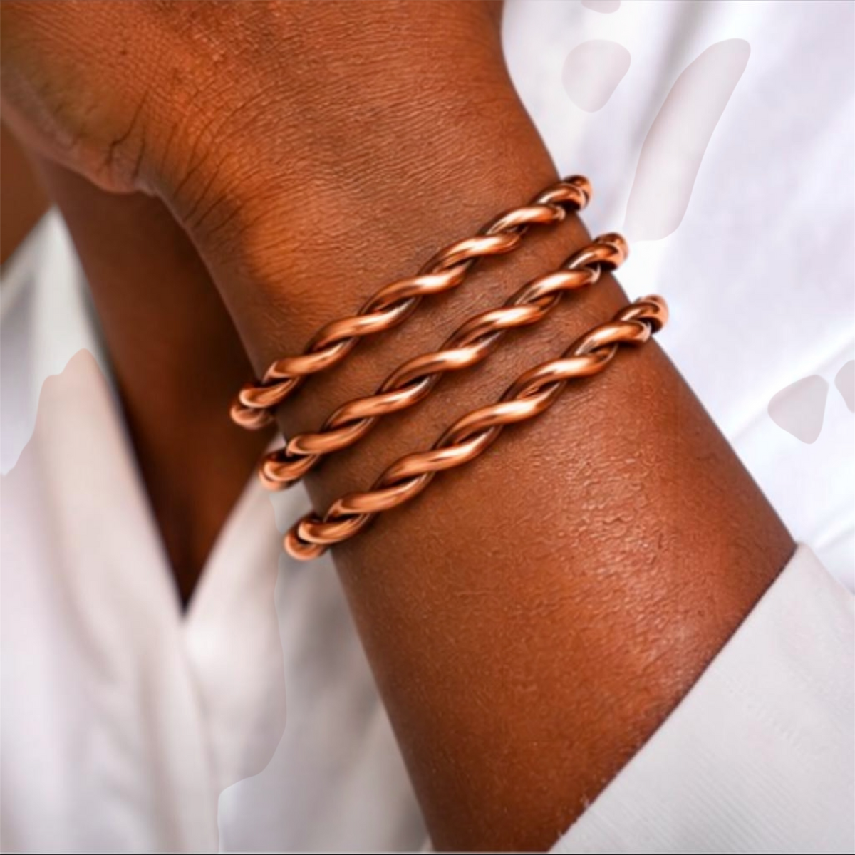 Three handmade pure copper twisted cuff bracelets worn together as a bracelet stack