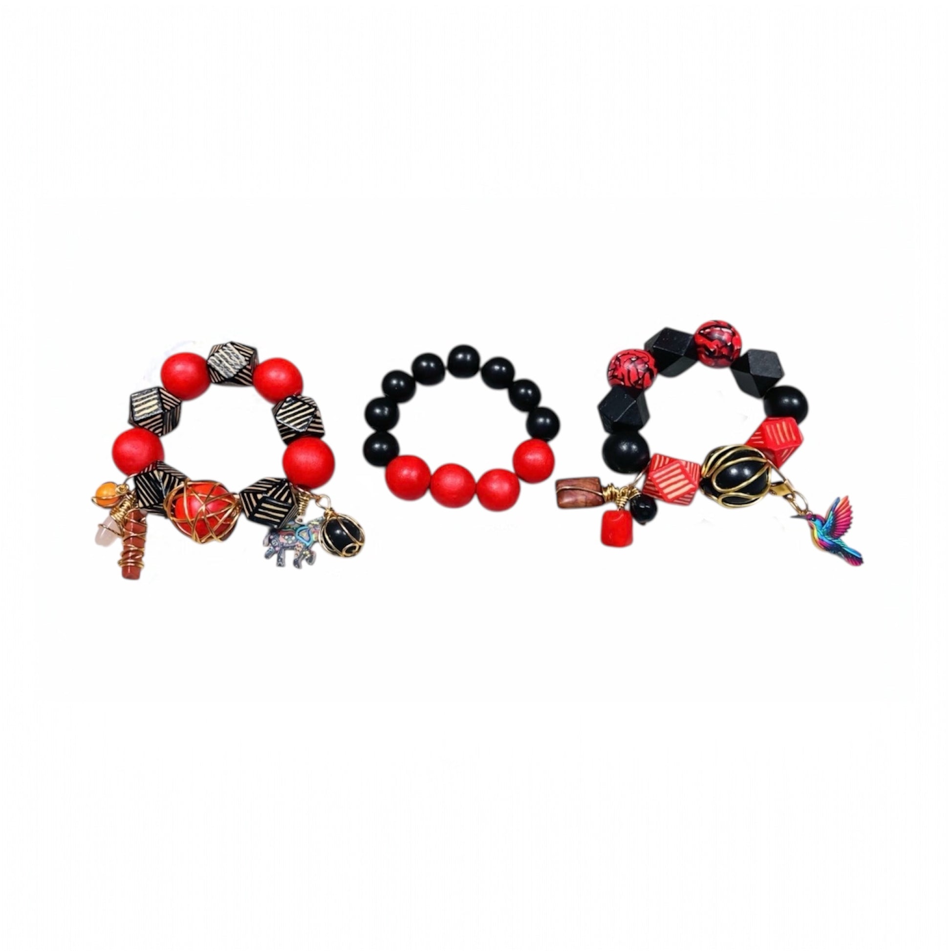 afrocentric bracelet stack trio se featuring red and black wooden beads,gold wrapped accents, geometric cube beads and colorful humming charm