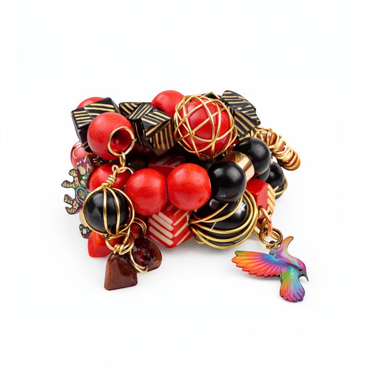 Handmade Afrocentric chunky bracelet stack with red and black wood beads and colorful hummingbird charm on white background
