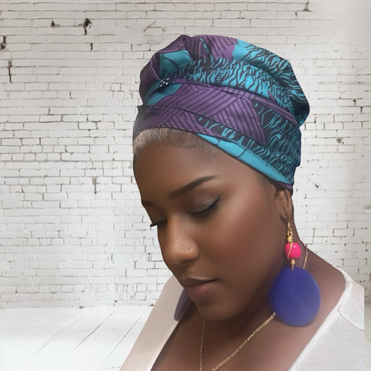 Woman wearing African Purple and teal print Headwrap with silk lining and matching wood earrings