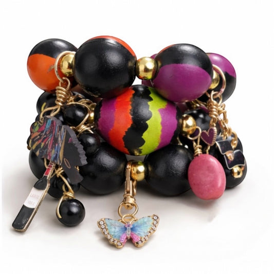 Handmade chunky Afrocentric wood bead charm bracelet trio stack with gold accents on white background