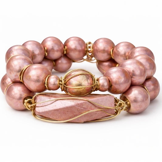 Queen Mother Blush Gold Afrocentric bracelet stack set with oversized blush metallic beads and gold wire-wrapped focal bead on white background